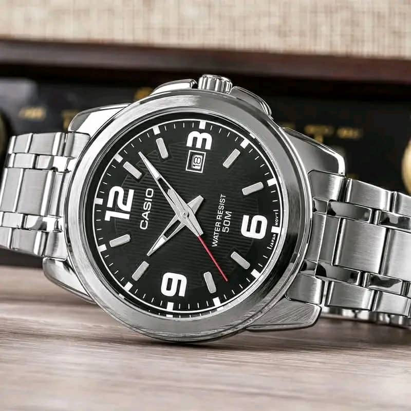Silver-tone chronograph-style watch with dark dial and black leather-look strap