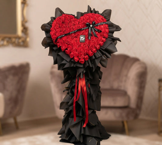 Red rose heart arrangement in a gift box with chocolates