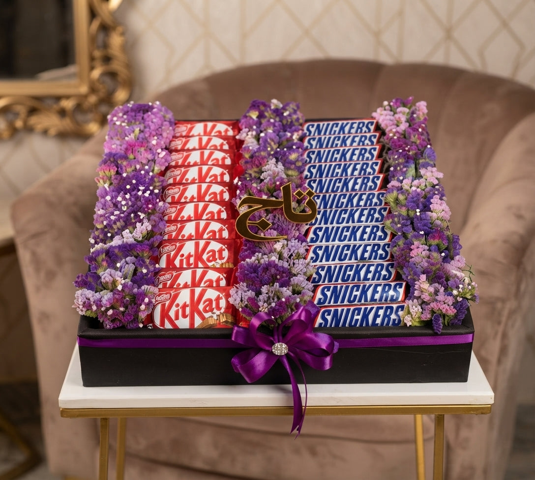 Purple flower gift arrangement with KitKat and Snickers chocolates