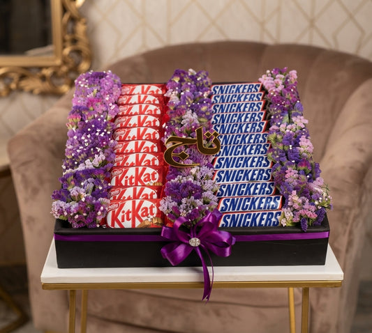 Purple flower gift arrangement with KitKat and Snickers chocolates