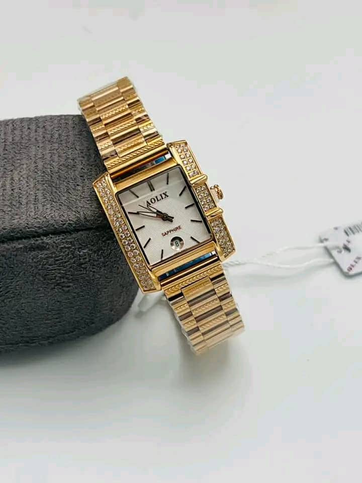 Silver rectangular watch with dark dial and matching bracelet
