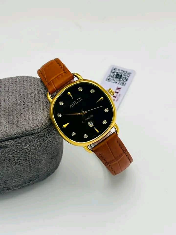 Gold-tone round watch with black dial and brown leather strap